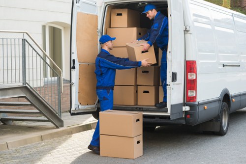 Professional movers carrying student furniture in Brent
