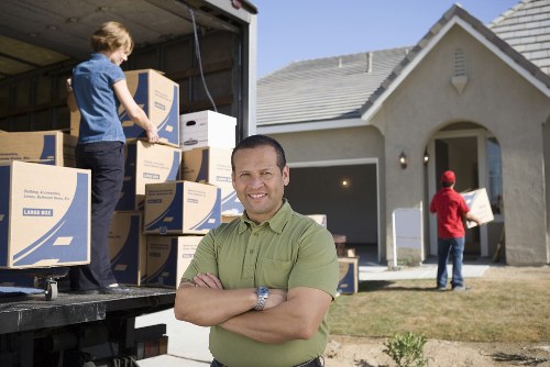 Removal team carrying boxed items safely during a planned move
