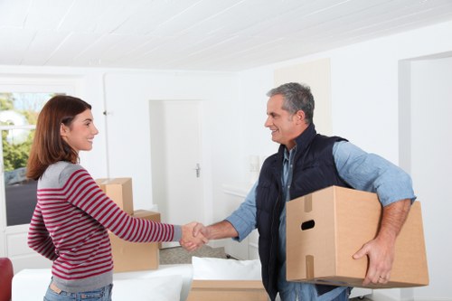Packed boxes and wrapped furniture ready for flat removals in Brent