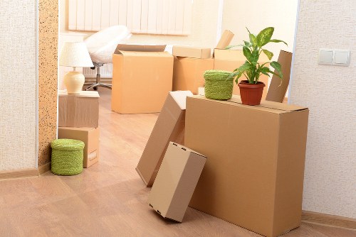 Packed office boxes and labelled desks ready for relocation in Brent