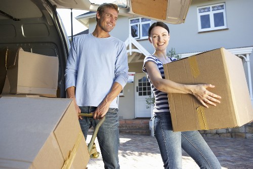 Worker using lifting equipment to move furniture safely